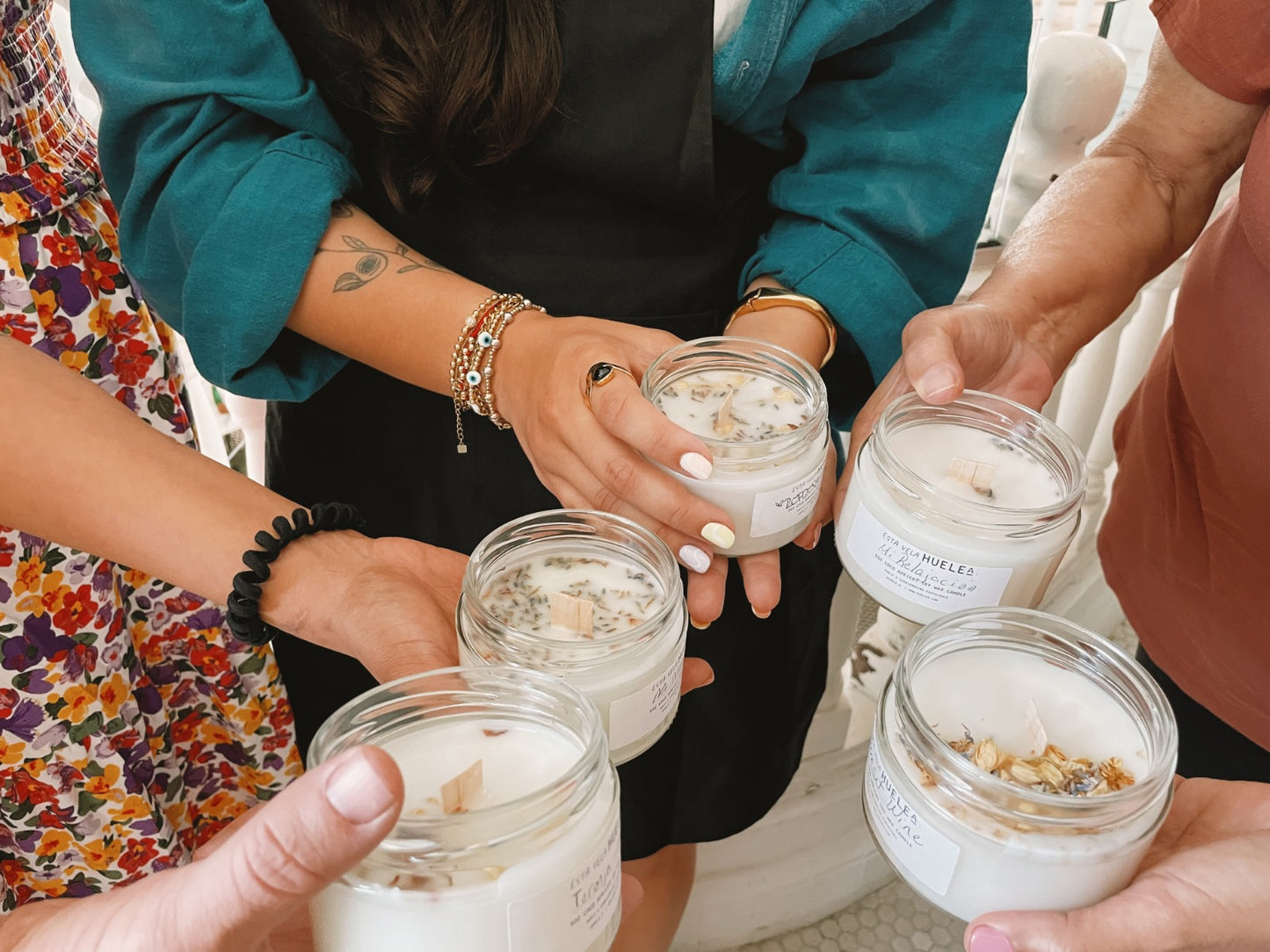 Group of people showing off their candle creations.
